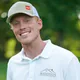 Smiling man in a cap and a white polo shirt